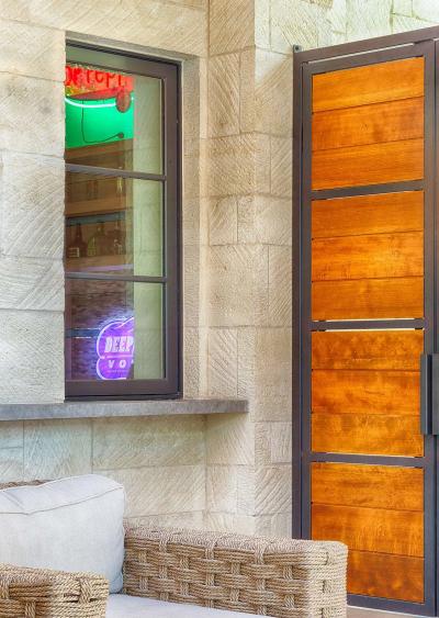 Covered patio with custom steel-and-wood entry door