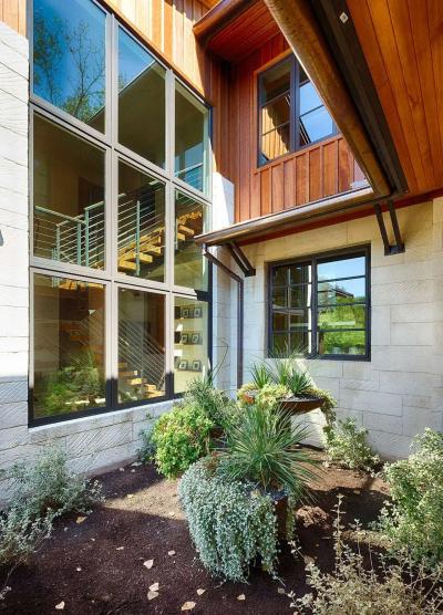Courtyard exterior — limestone, cedar siding, copper accents