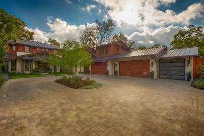 Front approach with paver motor court and four-bay garage