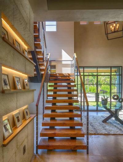 Floating oak treads with cable rails and lit picture ledges