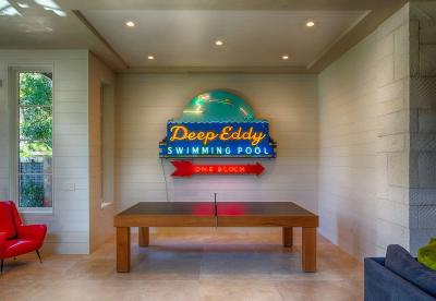 Game room with Deep Eddy neon and shiplap walls