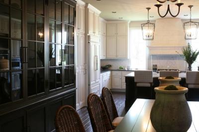 Custom black glass-front cabinetry framing the breakfast area