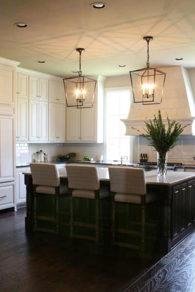 Bronze lantern pendants over the dark wood island